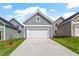 Detached garage with a white door, concrete driveway, and well-maintained lawn at 276 White Oak Garden Way # 210, Garner, NC 27529