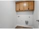 Laundry room offering storage with wood cabinets, washer and dryer hookups at 276 White Oak Garden Way # 210, Garner, NC 27529