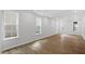 Bright, expansive living area with hardwood floors, white walls, and large windows providing natural light at 276 White Oak Garden Way # 210, Garner, NC 27529