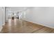 Open-concept living area with hardwood floors leading to the kitchen, featuring ample space and natural light at 276 White Oak Garden Way # 210, Garner, NC 27529