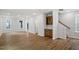 Bright, open living space with hardwood floors, neutral paint, and a built-in bar area near the stairway at 276 White Oak Garden Way # 210, Garner, NC 27529