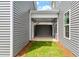 Inviting covered patio with a ceiling fan, door to backyard, and stylish gray siding at 276 White Oak Garden Way # 210, Garner, NC 27529