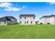 Spacious backyard surrounded by neighboring homes and lush green grass at 604 Spellbrook Rd, Zebulon, NC 27597