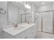 Stylish bathroom featuring double sink vanity, shower with glass door, and modern fixtures at 604 Spellbrook Rd, Zebulon, NC 27597