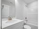 Bathroom features a vanity with a mirror, a toilet, and a bathtub shower at 604 Spellbrook Rd, Zebulon, NC 27597