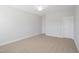 Bedroom with neutral carpet, walls, a door, and a ceiling fan at 604 Spellbrook Rd, Zebulon, NC 27597