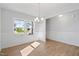 Bright dining room with elegant wainscoting, wood floors, and large windows at 604 Spellbrook Rd, Zebulon, NC 27597