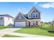 Charming two-story home featuring a two-car garage and a well-manicured front yard at 604 Spellbrook Rd, Zebulon, NC 27597