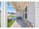 Inviting covered front porch with brick accents and ample natural light at 604 Spellbrook Rd, Zebulon, NC 27597