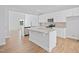 Modern kitchen featuring white cabinets, granite countertops, and stainless steel appliances at 604 Spellbrook Rd, Zebulon, NC 27597