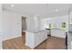 Modern kitchen featuring a center island, white cabinets, and stainless steel appliances at 604 Spellbrook Rd, Zebulon, NC 27597