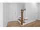 Staircase with wood flooring and white risers and bannister at 604 Spellbrook Rd, Zebulon, NC 27597