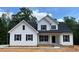 Newly constructed two-story house featuring white siding and black window trim at 1112 Armsleigh Ct, Raleigh, NC 27603