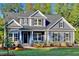 Charming two-story home with a landscaped front yard and a welcoming entryway at 1112 Armsleigh Ct, Raleigh, NC 27603