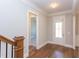 Welcoming foyer with hardwood floors, elegant lighting, and a view of the staircase at 1112 Armsleigh Ct, Raleigh, NC 27603