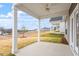 Covered patio with ceiling fan, overlooking grassy yard at 119 White Oak Garden Way # 52, Garner, NC 27529