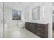 Bright bathroom featuring a modern soaking tub, walk-in shower with glass surround, and double sink vanity at 196 Mountaintop Cir, Pittsboro, NC 27312