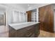 Walk-in closet with custom shelving and storage island featuring drawers and light countertops at 196 Mountaintop Cir, Pittsboro, NC 27312