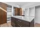 Spacious walk-in closet with custom built-ins, wooden sliding doors, and central island with light countertop at 196 Mountaintop Cir, Pittsboro, NC 27312