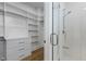 Organized closet with custom shelving and drawers visible from the bathroom, enhancing storage and convenience at 196 Mountaintop Cir, Pittsboro, NC 27312