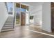 Grand foyer featuring a staircase, large windows and light hardwood flooring, showcasing the home's open design at 196 Mountaintop Cir, Pittsboro, NC 27312