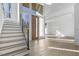 Bright foyer with a staircase, hardwood floors, and a large window with a wooden front door at 196 Mountaintop Cir, Pittsboro, NC 27312