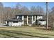 Stunning modern home exterior surrounded by mature trees and lush greenery at 196 Mountaintop Cir, Pittsboro, NC 27312