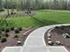 Well-manicured front yard featuring a charming walkway and lush landscaping at 196 Mountaintop Cir, Pittsboro, NC 27312