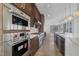 Modern kitchen with stainless steel appliances and a spacious island overlooking the bright, open-concept living area at 196 Mountaintop Cir, Pittsboro, NC 27312