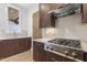 Modern kitchen with stainless steel stove, wooden cabinets, and light countertops at 196 Mountaintop Cir, Pittsboro, NC 27312
