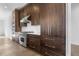 Gourmet kitchen features Wolf range, stainless steel appliances, custom cabinetry, and quartz countertops at 196 Mountaintop Cir, Pittsboro, NC 27312