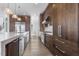 Gourmet kitchen features an island, stainless steel appliances, custom cabinetry, and quartz countertops at 196 Mountaintop Cir, Pittsboro, NC 27312