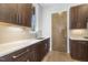 Kitchenette area featuring sleek countertop, cabinets, and stainless steel sink and faucet at 196 Mountaintop Cir, Pittsboro, NC 27312