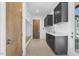 Laundry room with dark cabinets, built-in storage, and a quartz countertop at 196 Mountaintop Cir, Pittsboro, NC 27312