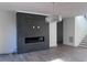 Living room showcasing a modern fireplace, hardwood floors, and a stylish chandelier at 196 Mountaintop Cir, Pittsboro, NC 27312