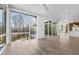 Open-concept living space with hardwood floors, large windows, and access to a deck at 196 Mountaintop Cir, Pittsboro, NC 27312