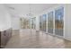Bright living room with floor to ceiling windows, modern chandelier, and custom cabinets with quartz counters at 196 Mountaintop Cir, Pittsboro, NC 27312