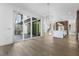 Open-concept living room featuring hardwood floors, sliding glass doors, and a modern kitchen at 196 Mountaintop Cir, Pittsboro, NC 27312