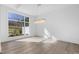 Spacious living room with hardwood floors, large window offering a view and modern chandelier at 196 Mountaintop Cir, Pittsboro, NC 27312