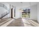 Bright and spacious living room with hardwood floors, large windows and door, and a modern staircase with metal railing at 196 Mountaintop Cir, Pittsboro, NC 27312