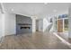 An open floor plan living area featuring a modern fireplace and contemporary chandelier with views of the entryway and stairs at 196 Mountaintop Cir, Pittsboro, NC 27312