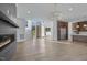 Expansive open-concept living room featuring a fireplace, modern chandelier, and views into the kitchen and entryway at 196 Mountaintop Cir, Pittsboro, NC 27312