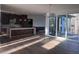 Modern open-concept living space with hardwood floors, large windows, and a sleek kitchen at 196 Mountaintop Cir, Pittsboro, NC 27312