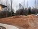 Cleared lot ready for construction, showing the potential for a new home with access to a paved road at 196 Mountaintop Cir, Pittsboro, NC 27312