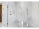 Spacious walk-in shower featuring white marble, rainfall shower head, handheld sprayer, and shower seat at 196 Mountaintop Cir, Pittsboro, NC 27312