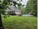 View of the backyard with a gorgeous pool and luscious grass at 2012 Silverleaf Dr, Youngsville, NC 27596