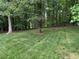 Large, private backyard featuring mature trees and plenty of space for outdoor activities at 2012 Silverleaf Dr, Youngsville, NC 27596