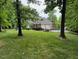 Beautiful backyard with an in-ground pool and mature trees creating a private and serene outdoor space at 2012 Silverleaf Dr, Youngsville, NC 27596