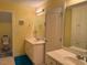 Bright bathroom featuring double sink vanity, linen closet, and neutral tile at 2012 Silverleaf Dr, Youngsville, NC 27596