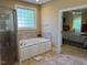 Bathroom with soaking tub, walk-in shower, and tile flooring at 2012 Silverleaf Dr, Youngsville, NC 27596